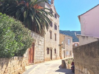 sandstone streets in with colourful houses and blue sky on croatia road trip